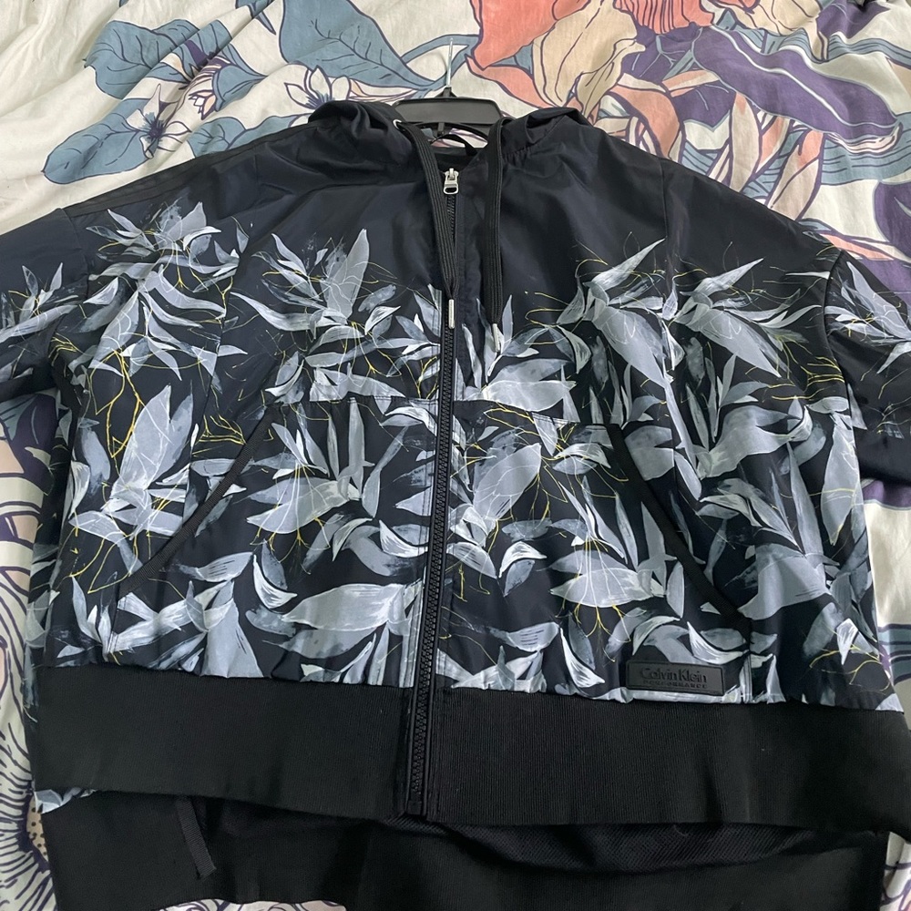 Calvin Klein floral windbreaker with navy base in a size small, cropped.